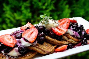 Pancakes with berries on a rectangular plate