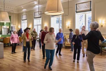 Homeowners line dancing together at Mote House Bearsted retirement village