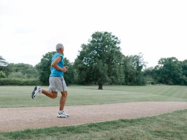 Older man running in park