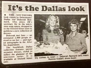 Newspaper clipping featuring two women standing in clothing store, with text about Dallas TV show attire available at a store event, where an actress meets fans and signs autographs.
