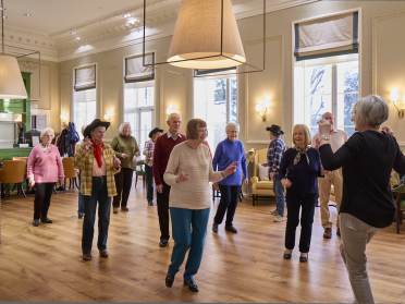 Homeowners line dancing together at Mote House Bearsted retirement village
