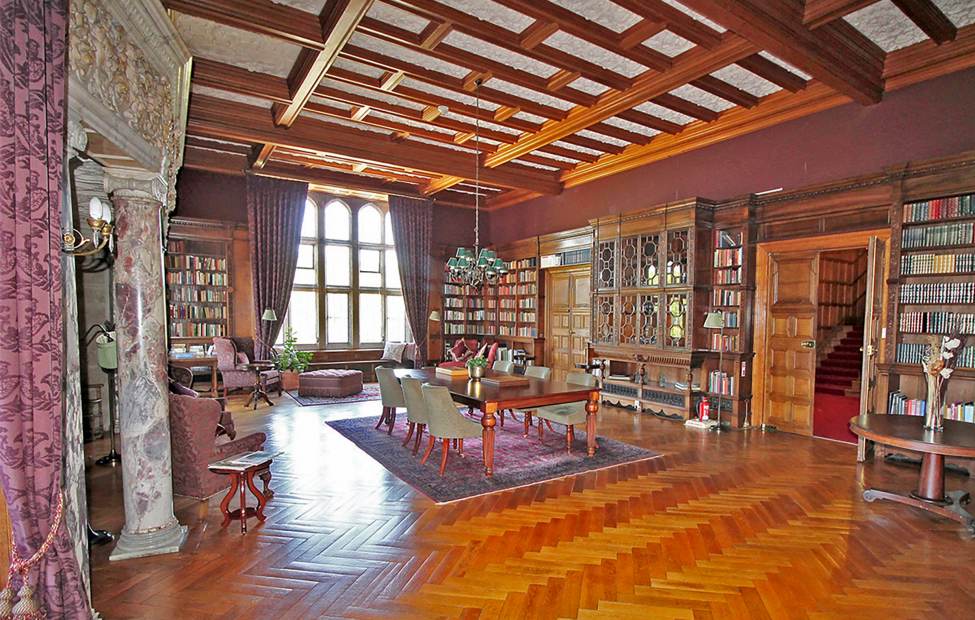 Parquet and panelling in the library at Flete House Wood-panelled library with parquet floor