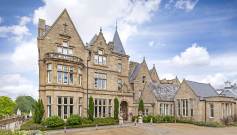 Victorian gothic stone buildings under a blue sky