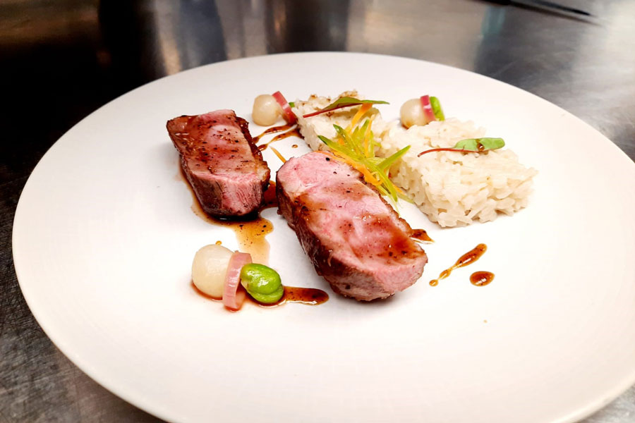 Honey and Szechuan pepper glaze duck breast with sticky coconut rice, broad beans, and stem ginger