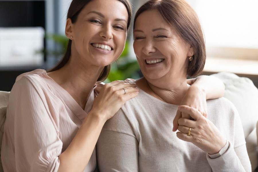 A smiling mother and daughter