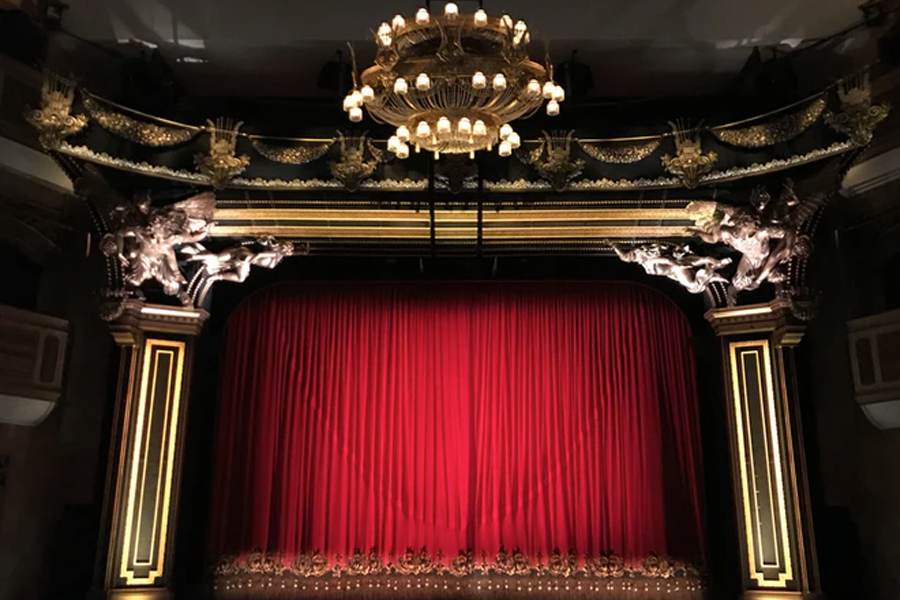 Red stage curtains in a luxurious theatre